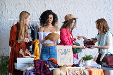Young Women At Swap Party. Casual Clothes, Shoes, Hats, Bags, Jewellery. Idea Of Exchange Your Old Wardrobe For New. Eco Friendly Cloth Concept. Zero Waste Shopping, Reduce And Reuse, Donation