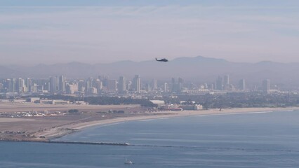 Wall Mural - San Diego city skyline, cityscape of downtown with highrise skyscrapers, California coast, USA. View of Coronado island from above, Point Loma vista viewpoint. Helicopter flying mid air in sky.