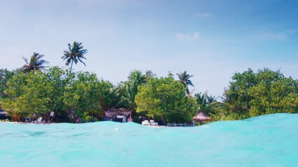 Wall Mural - Tropical island of Thulushdoo with turquoise sea water in Maldives