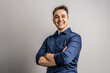 © Miljan Živković - Portrait of one adult caucasian man 25 years old looking to the camera in front of white wall background smiling wearing casual blue shirt copy space