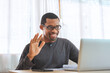 © eggeeggjiew - Happy african american man smiling face waving hand talking to webcam, Black male making video call at home.