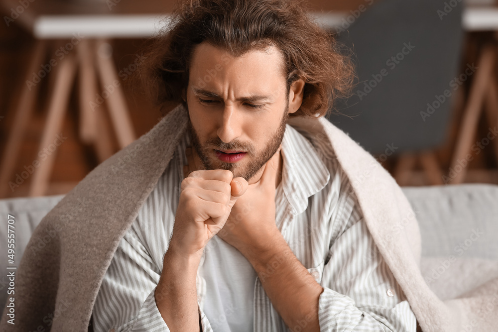 Ill man with sore throat at home