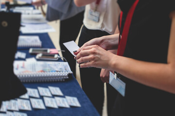process of checking in on a conference congress forum event, registration desk table, visitors and a