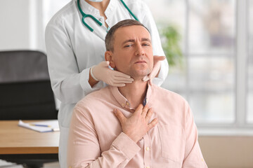 Poster - Doctor examining man's neck in clinic