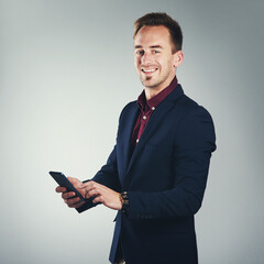 Poster - Call me and connect with the best. Studio portrait of a confident young businessman using a mobile phone against a gray background.