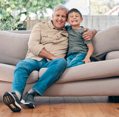 Poster - Quality time with gramps is great. Portrait of an adorable little boy relaxing with his grandfather on the sofa at home.