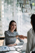 © Natee Meepian - Young asian business people shaking hands in the office. Finishing successful meeting.