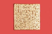Matzah For Jewish Holiday Pesach On Red Background.