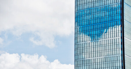 Wall Mural - Part of modern office building against blue sky