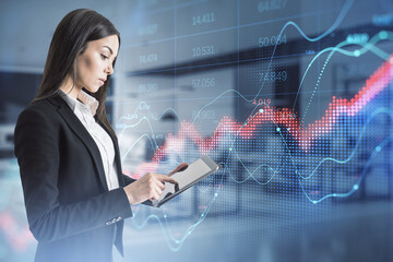 Wall Mural - Attractive young white businesswoman using tablet with abstract red forex chart index on blurry office interior background. Digital data, company and crisis concept. Double exposure.