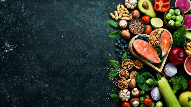 Keto, Ketogenic diet, low carb, healthy food. On a black stone background. Top view. Copy space.