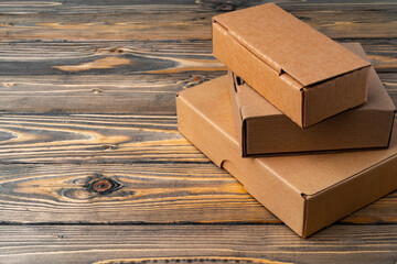 Wall Mural - Pile of cardboard boxes on wooden background