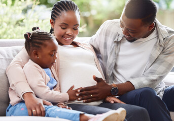 Poster - They couldnt be happier. Cropped shot of an attractive young pregnant woman sitting on the sofa at home with her husband and daughter.