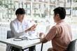 © Freedomz - Male doctor discussing with the patient explaining symptoms of the disease after diagnosis checking while recommending treatment methods in clinic