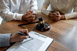 © Freedomz - Unhappy divorce couple having conflict, husband and wife during divorce process with senior male lawyer or counselor and couple signing decree of divorce contract in lawyer's office