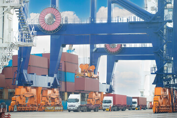 The container vessel during loading at an industrial port by port crane.