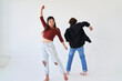 woman arm up dancing with man facing away