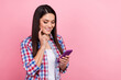 © deagreez - Photo of dreamy thoughtful lady dressed checkered shirt chatting gadget empty space isolated pink color background
