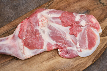 Wall Mural - Raw meat shoulder of mutton on a cutting board. Lamb leg fillet ready to cook. Selective focus