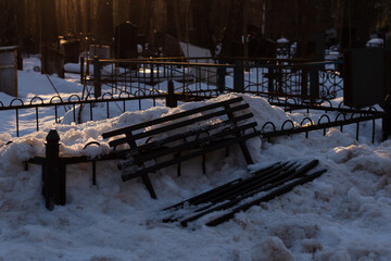 Sticker - Photo of a broken bench in cemetery in snow in Moscow