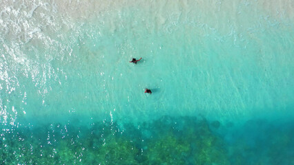 Sticker - Aerial Shot girls swim in the turquoise, clear water of Gili Meno Island, Lombok, Indonesia.