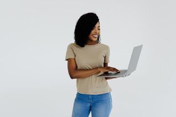 Poster - Happy afro woman using laptop isolated over white background