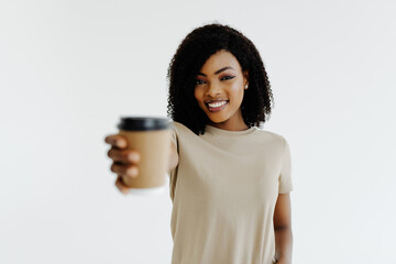 Poster - Pleased woman in hat drinking coffee over white background