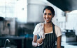 © Nicholas Felix/peopleimages.com - The queen of the catering industry. Portrait of a confident young woman standing in the kitchen of her cafe.