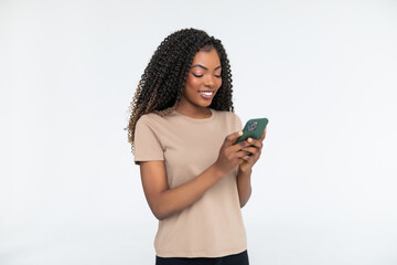 content smiling african woman typing text message or using internet on phone isolated over white bac