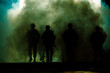 Leinwandbild Motiv silhouette group of thai soldiers special forces full team in uniform walking action through smoke and holding gun on hand and over the lighting background.