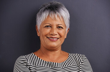 Sticker - Enjoying a good long life. Portrait of a mature woman standing in a studio.