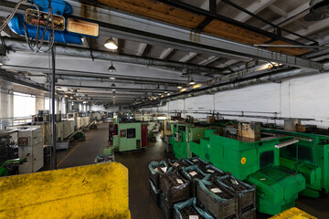 Wall Mural - Photo of modern automatic automobile manufacturing workshop. Factory with steel constructions. Plant of car production. Industrial scenery background. Yellow and green