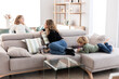 © ADDICTIVE STOCK - Mother spending time with children in living room
