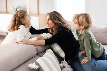 Mother Spending Time With Children In Living Room
