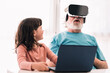© ADDICTIVE STOCK - Grandfather in VR headset playing videogame near girl