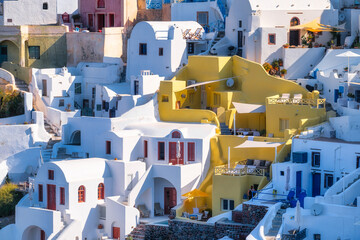 Wall Mural - Oia village, Santorini, Greece. Architectural background. View of traditional houses in Santorini. Small narrow streets and rooftops of houses and hotels. Travel and vacation photography.