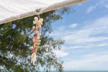 Seashell Souvenir Hanging Decoration On Gazebo With Tropical Beach