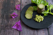 Plate of Japanese horseradish or wasabi with bougainvilleas on a wooden table