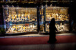 muslim woman in burqa view the windows in the gold souk in Dubai
