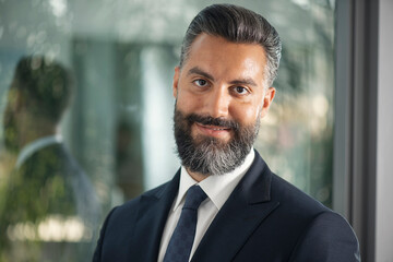 happy young businessman posing in a modern office 
