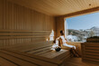 © BGStock72 - Young man relaxing in the sauna and watching winter forest through the window