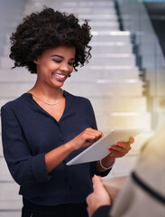 Canvas Print - Paperless convenience. Shot of a happy businesswoman using a tablet while accepting a package from a courier in the office.