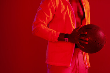 Poster - I aspire to be a professional basketball player. Red filtered shot of an unrecognizable sportsman posing with a basketball in the studio.