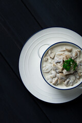 Wall Mural - Cream sauce with mushrooms, top view, on a dark gray wooden table, horizontal , no people,