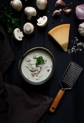 Wall Mural - Cream sauce with mushrooms, top view, on a dark gray wooden table, horizontal , no people,