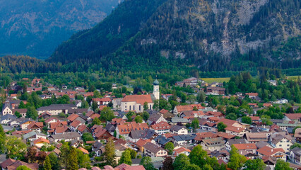 Aerial view over the city of Oberammergau in Bavaria Germany. High quality 4k drone footage