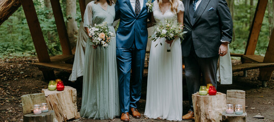 Bridal couple with friends posing for a wedding group picture