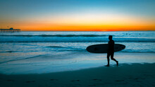 Silhouette Of A Guy Going To Surf At The San Clemente Beach