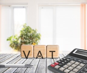 Wall Mural - Wooden cubes with calculator and a pen on a table.