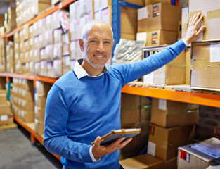 Poster - Doing a job well is its own reward. Portrait of a man standing next to industrial shelving with boxes.